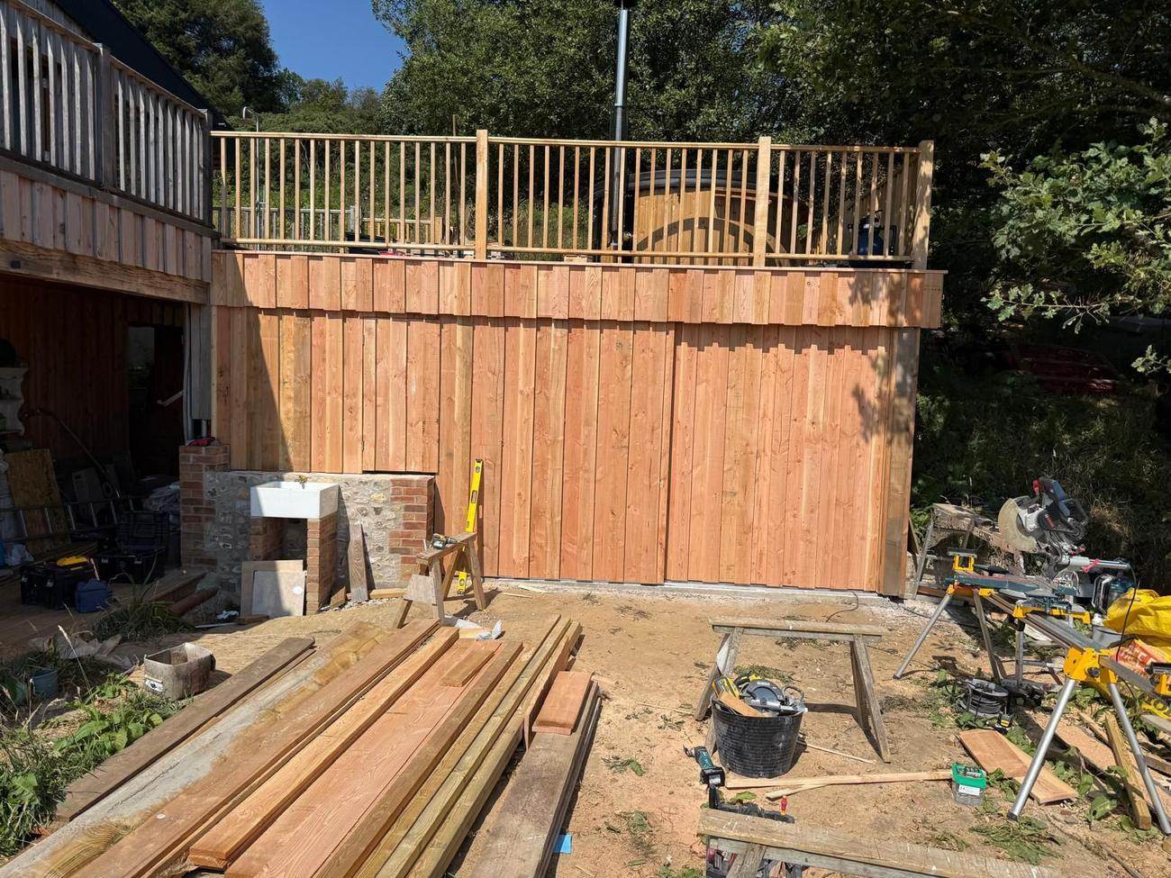 Raised timber deck and balustrade with vertical cladding, West Dorset