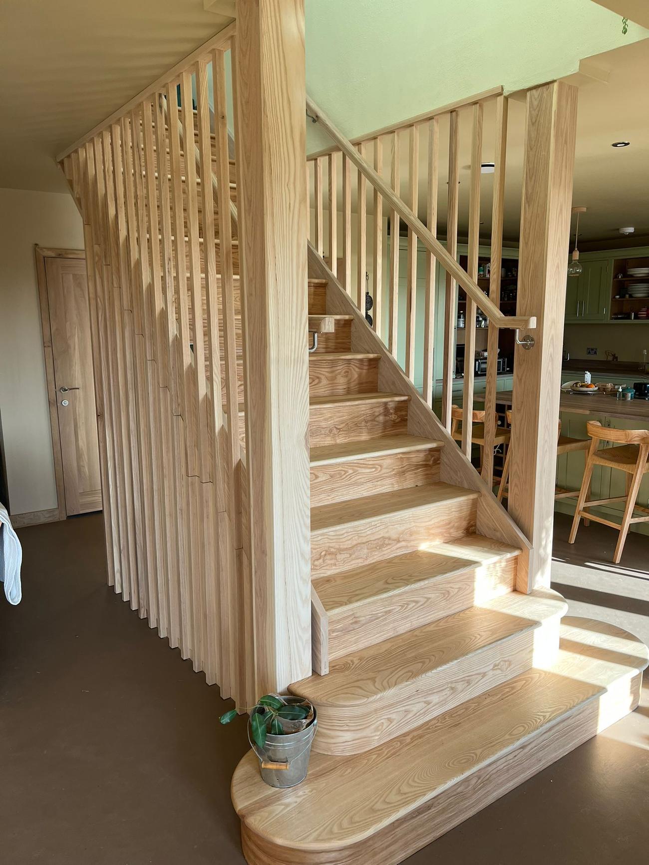 Ash staircase with a slatted timber screen in a renovated Dorset farmhouse