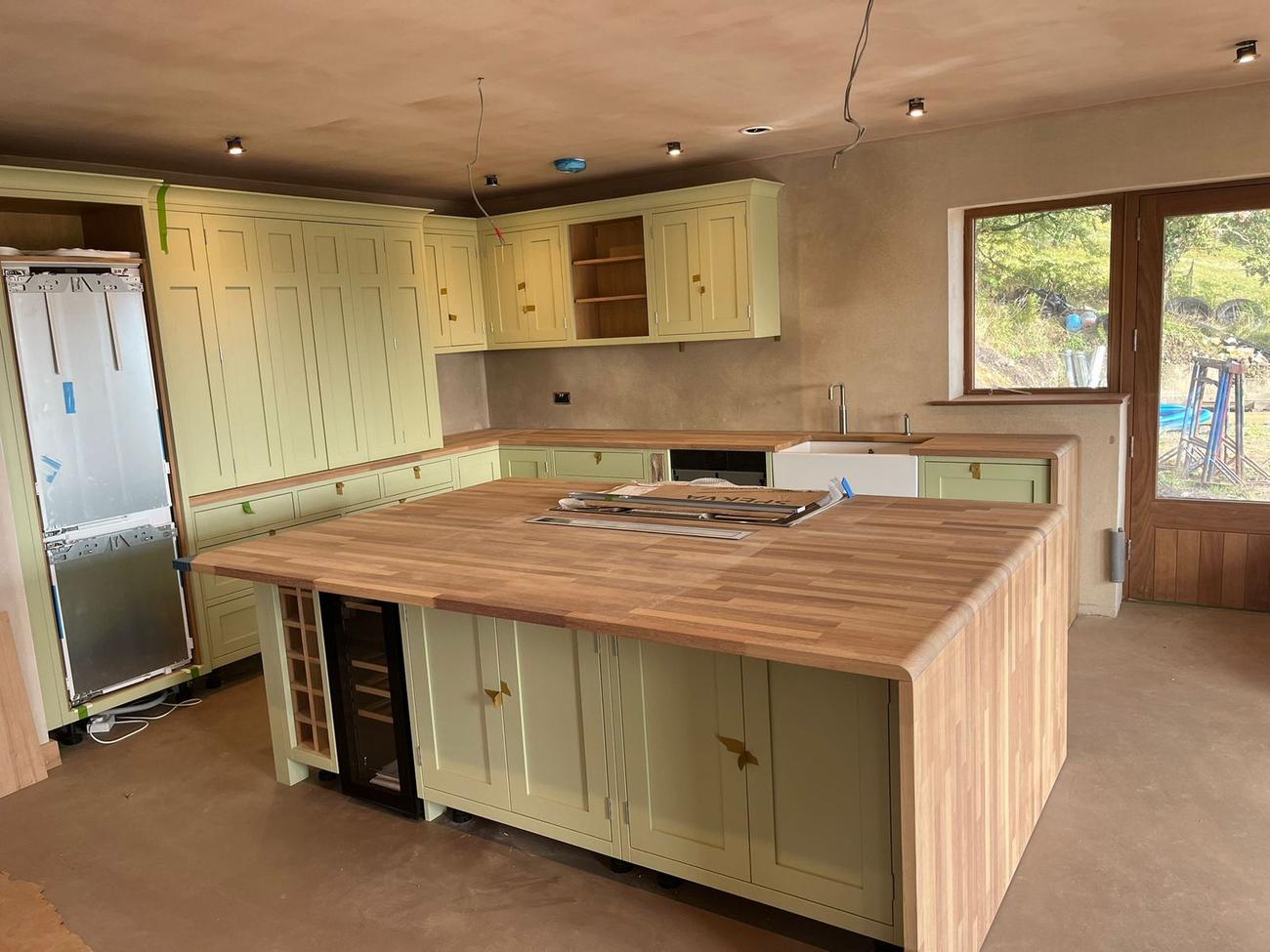 Hand-painted shaker kitchen with an oak island fitted by Chapman Building and Plastering