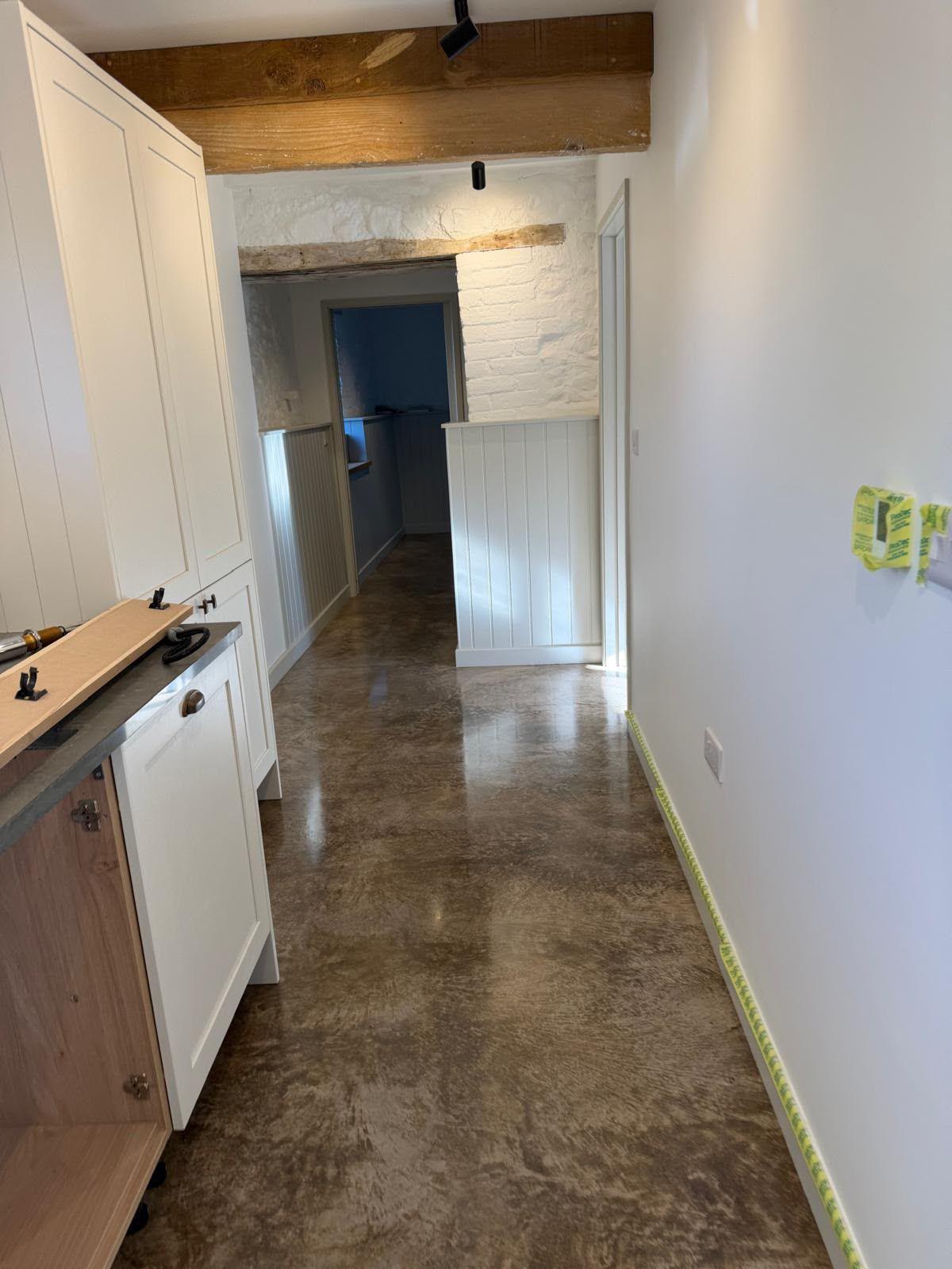 Freshly plastered walls and exposed beam in a Dorset farmhouse renovation