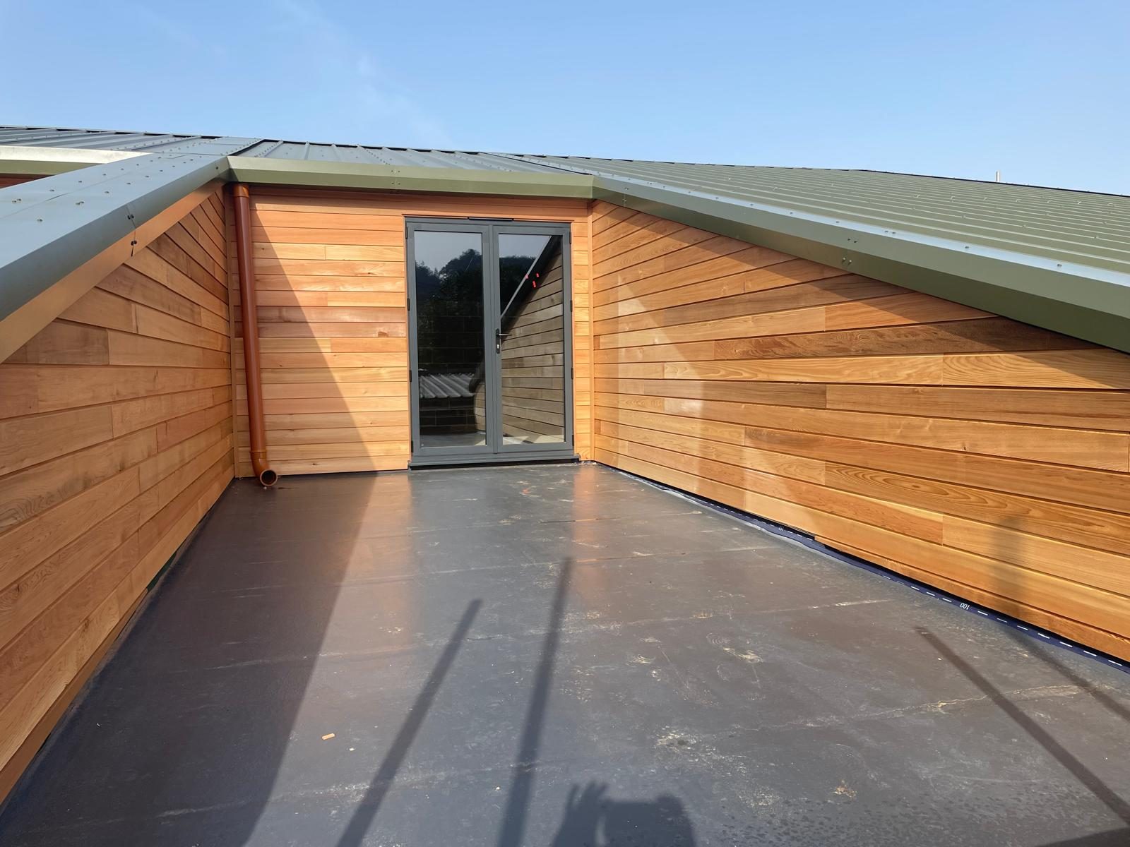 Larch cladding wrapping a flat roof terrace