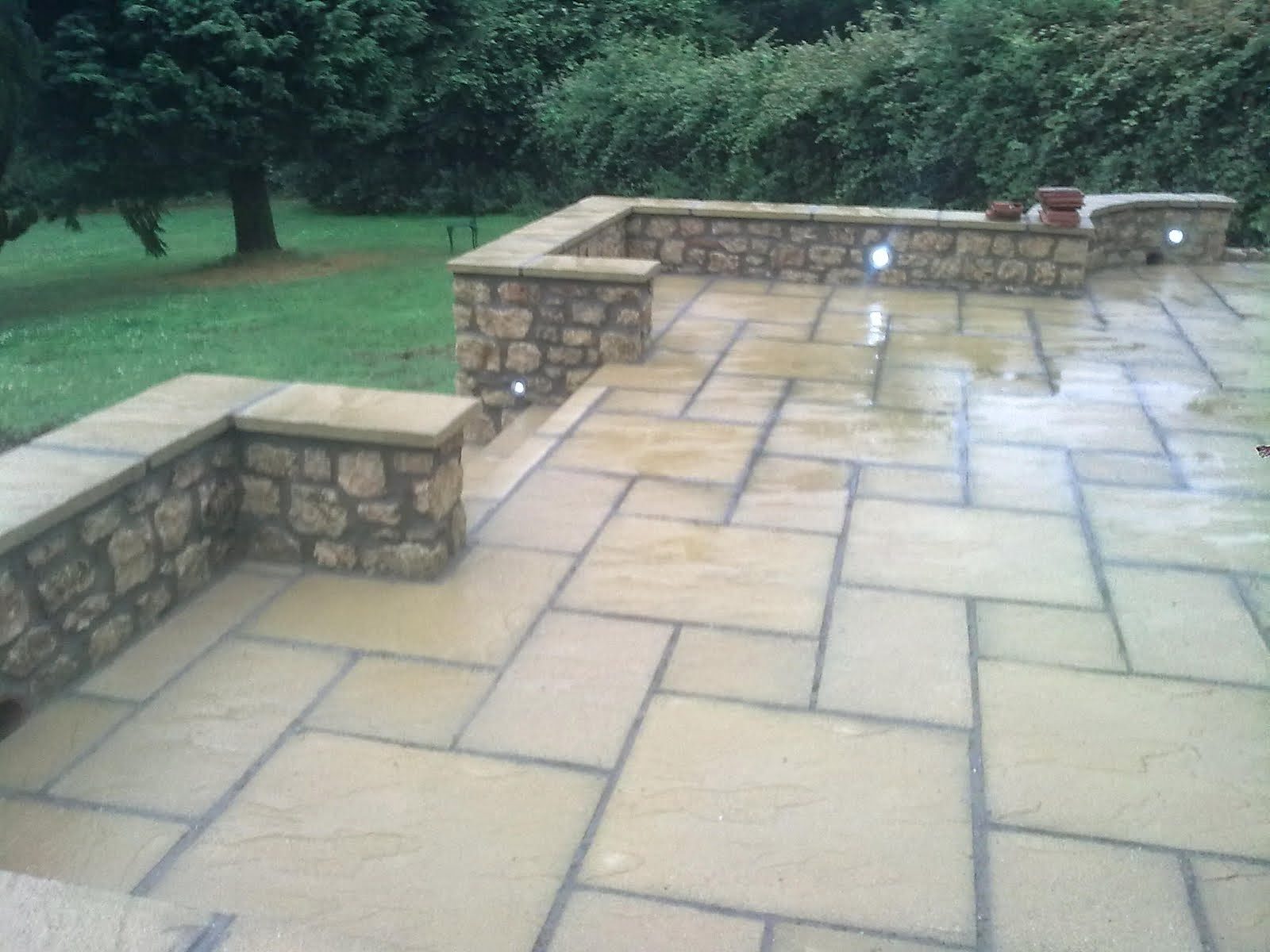 Patio walls coursed in local stone with sandstone paving